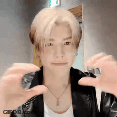 Young Man In Black Leather Jacket Making Heart With Hands GIF