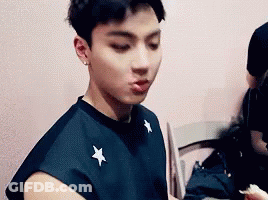 Young Man In Black Shirt Eating GIF