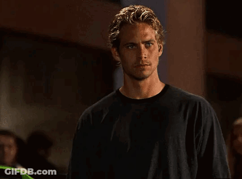 Young Man In Black Shirt In Dark Room GIF
