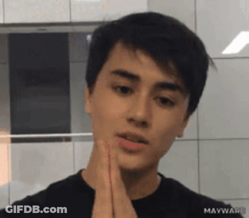 Young Man In Black Shirt Looking At Camera GIF