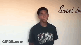 Young Man In Black Shirt Saying Billionaire In Front Of Sweet Dream Wall GIF