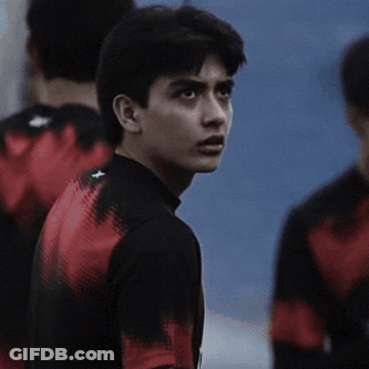 Young Man In Black Shirt With Red Stripe Sleeves GIF