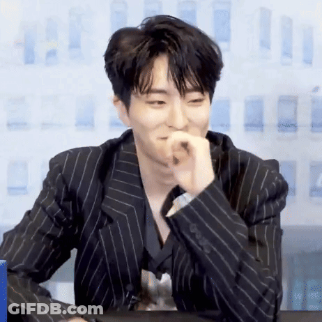 Young Man In Black Striped Suit Sitting GIF