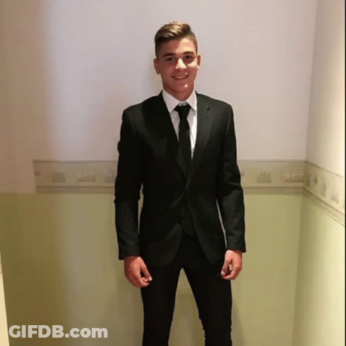 Young Man In Black Suit And Tie Hallway GIF