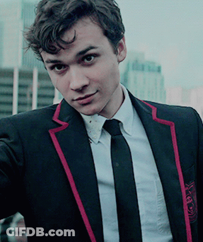 Young Man In Black Suit With Red Stripe Sleeves GIF