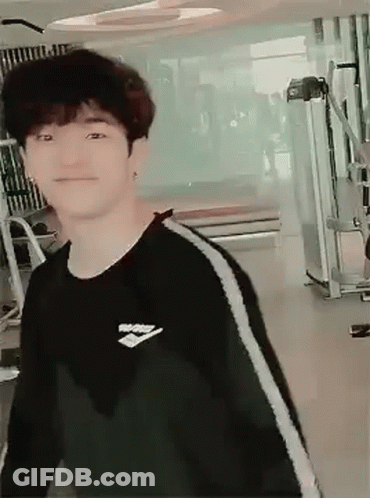 Young Man In Black Sweater Smiling At Gym GIF