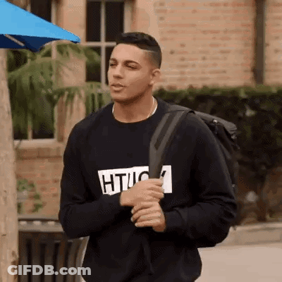 Young Man In Black Sweatshirt And Backpack GIF