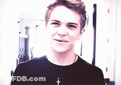 Young Man In Black T-Shirt Smiling With Cross Necklace GIF