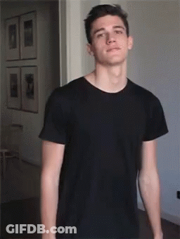 Young Man In Black T-Shirt With Arms Outstretched GIF