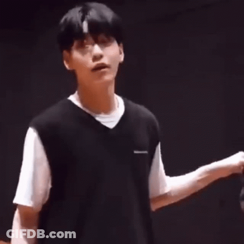 Young Man In Black Vest And White T-Shirt Hands Folded GIF
