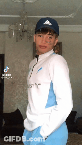 Young Man In Blue Adidas Hat And White Sweater GIF