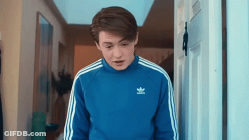 Young Man In Blue Adidas Sweater Standing In Doorway GIF