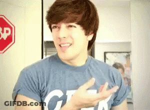 Young Man In Blue Geek Shirt At Stop Sign GIF