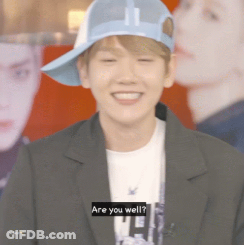 Young Man In Blue Hat And Black Jacket Saying Are You Well GIF