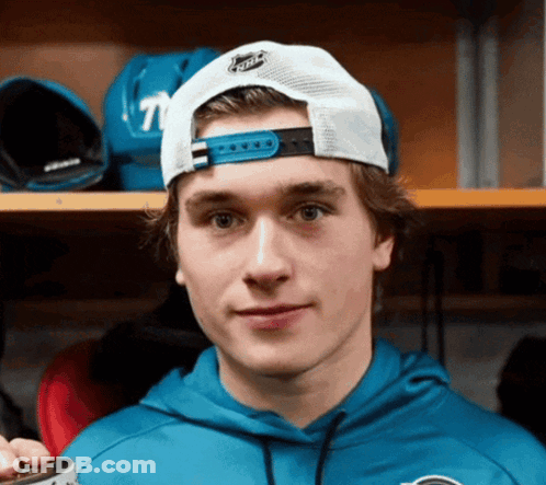 Young Man In Blue Hoodie And White NHL Hat GIF