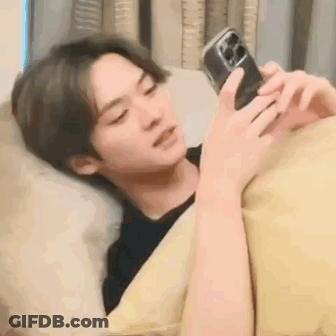 Young Man In Blue Hoodie Laying Down GIF