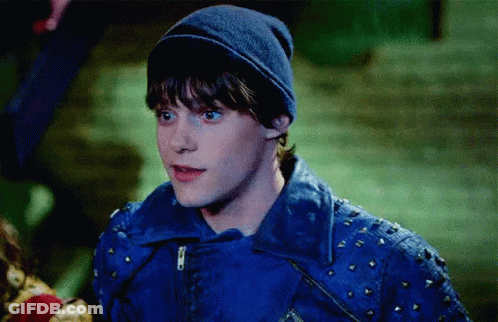 Young Man In Blue Jacket And Beanie In Dark GIF