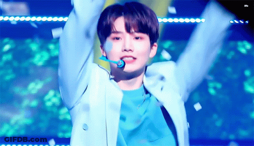 Young Man In Blue Jacket Arms Up Confetti GIF