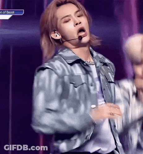 Young Man In Blue Jacket Singing Into Microphone GIF