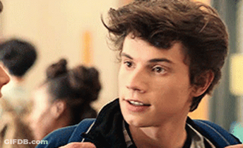 Young Man In Blue Jacket Talking To Woman GIF