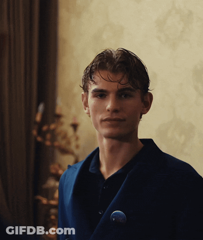 Young Man In Blue Jacket With Button Saying A GIF
