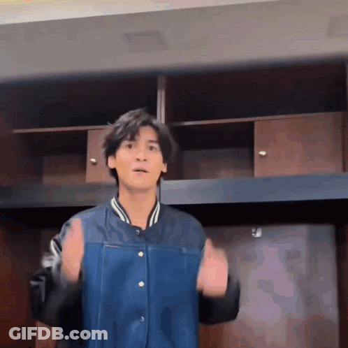 Young Man In Blue Jacket With Hands Up GIF