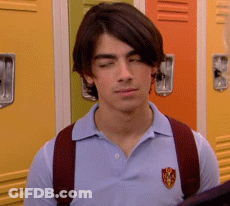 Young Man In Blue Polo And Red Backpack By Lockers GIF