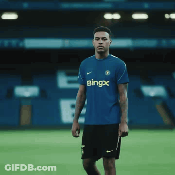Young Man In Blue Shirt Adjusting Tie GIF
