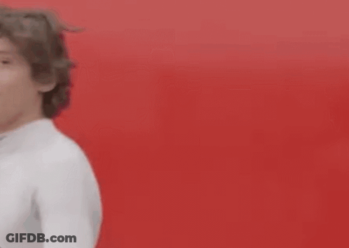 Young Man In Blue Shirt And Black Bag Pointing At Camera GIF