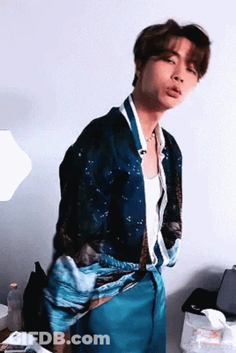 Young Man In Blue Shirt And Blue Pants Standing In Room GIF