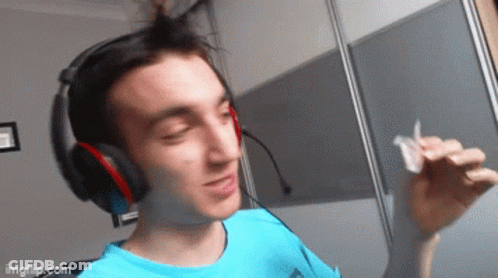 Young Man In Blue Shirt And Headphones Holding Paper GIF