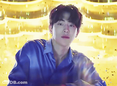 Young Man In Blue Shirt Gold Background GIF