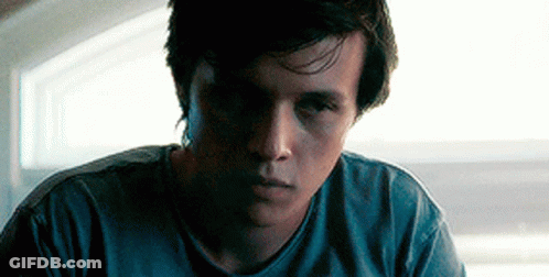 Young Man In Blue Shirt Looking At Camera GIF