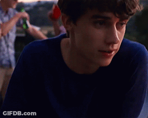 Young Man In Blue Shirt Looking Left GIF