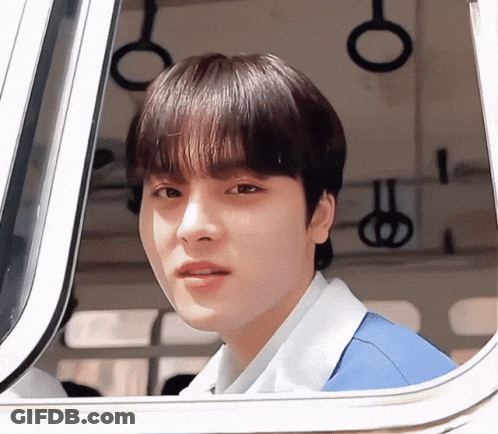 Young Man In Blue Shirt Looking Out Window GIF
