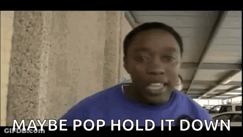 Young Man In Blue Shirt Standing In Parking Garage GIF