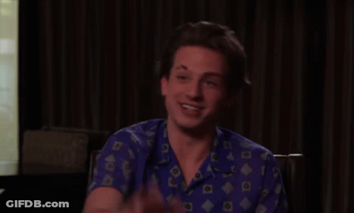 Young Man In Blue Shirt Waving GIF