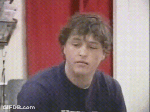 Young Man In Blue Shirt With Letter T GIF
