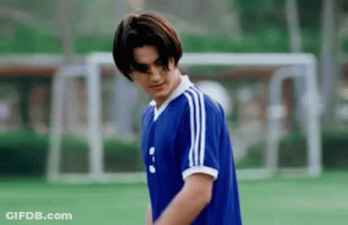 Young Man In Blue Soccer Jersey Standing On Field GIF