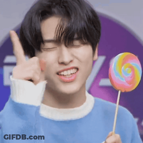 Young Man In Blue Sweater Holding Lollipop Thumbs Up GIF