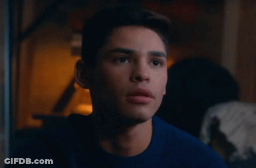 Young Man In Blue Sweater Looking At Camera GIF