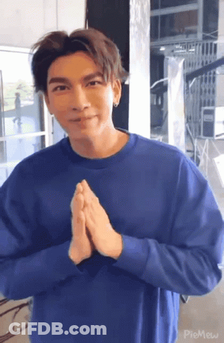 Young Man In Blue Sweater Making Funny Face GIF