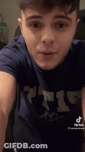 Young Man In Blue T-Shirt Standing GIF