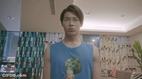 Young Man In Blue Tank Top With Cartoon Character GIF