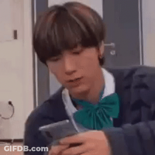 Young Man In Bow Tie Holding Cell Phone GIF