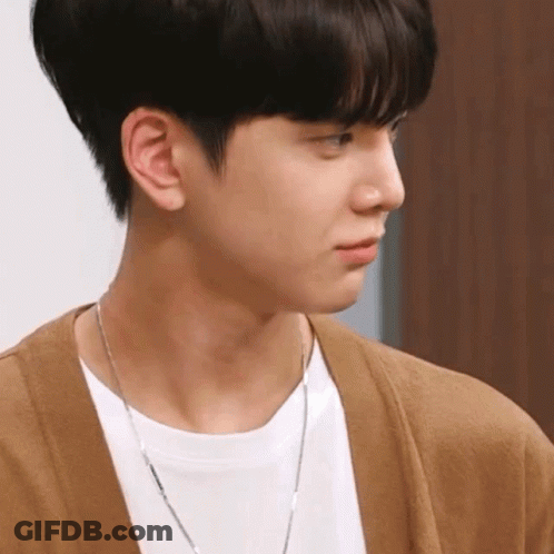 Young Man In Brown Cardigan And Silver Chain GIF