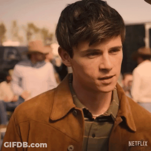 Young Man In Brown Jacket And Plaid Shirt GIF