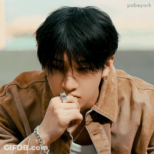 Young Man In Brown Jacket With Ring GIF