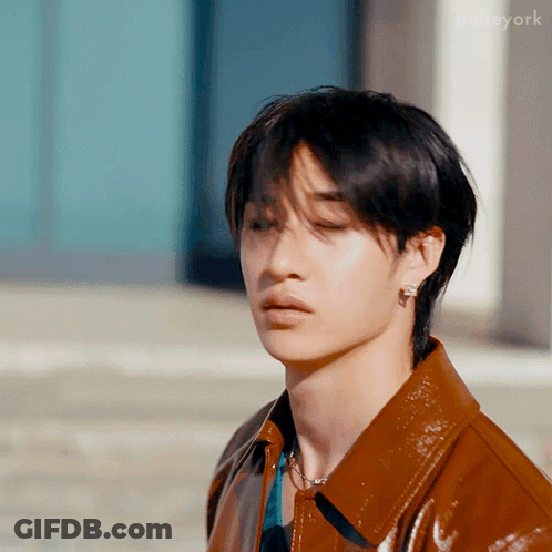 Young Man In Brown Leather Jacket With Earrings GIF