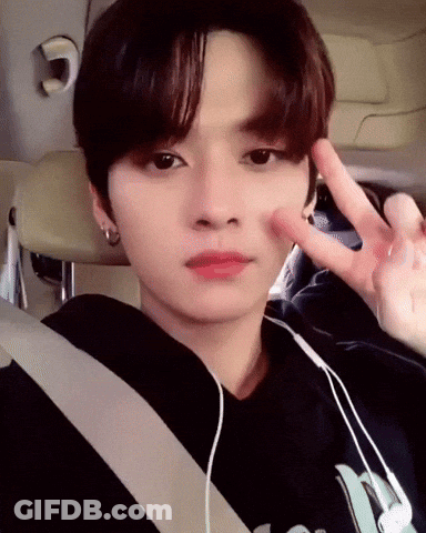 Young Man In Car With Headphones Giving Peace Sign GIF